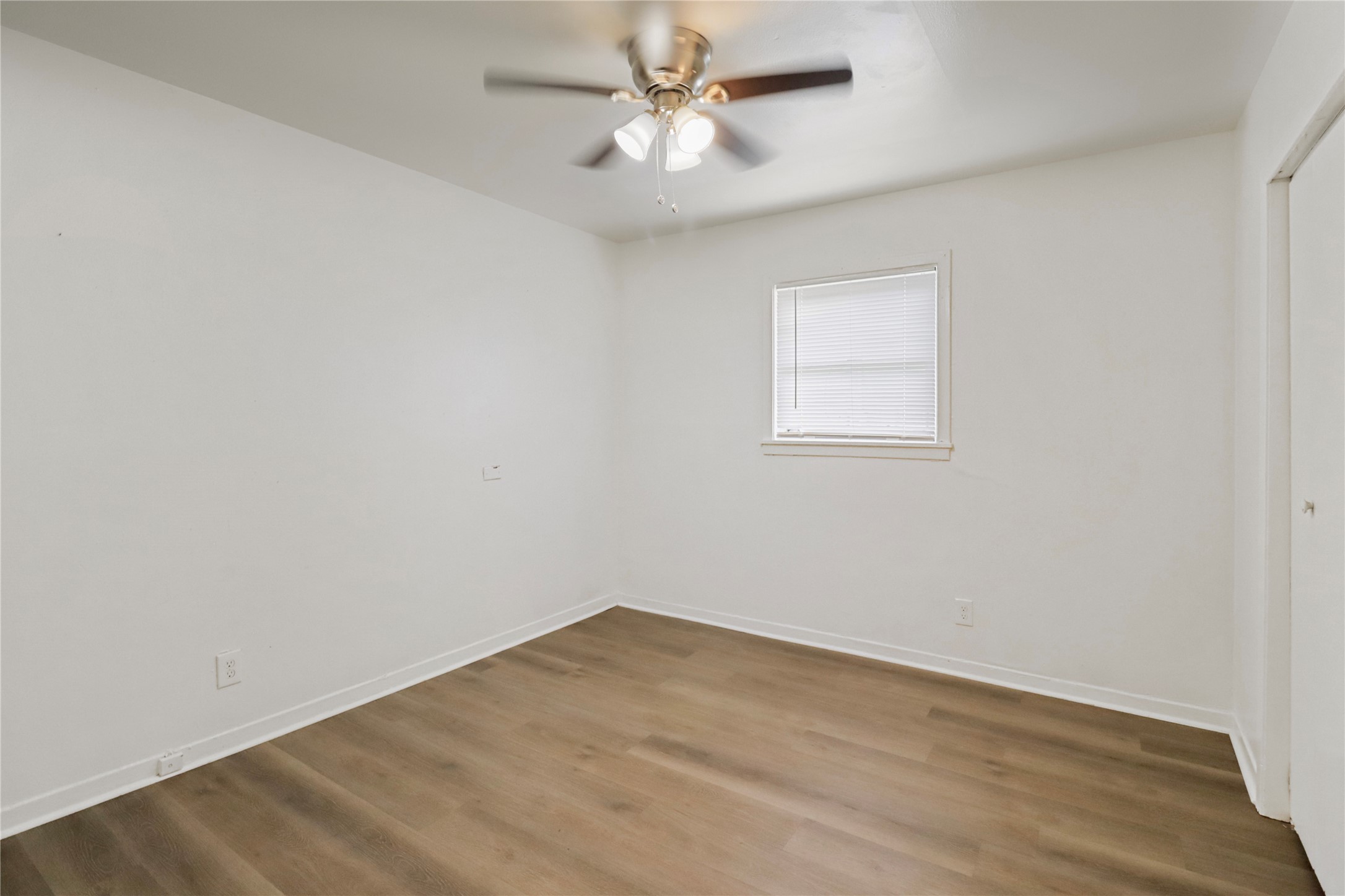604 West Peach Street Angleton, TX 77515 - Photo 14 of 15 an empty room with a window and a fan