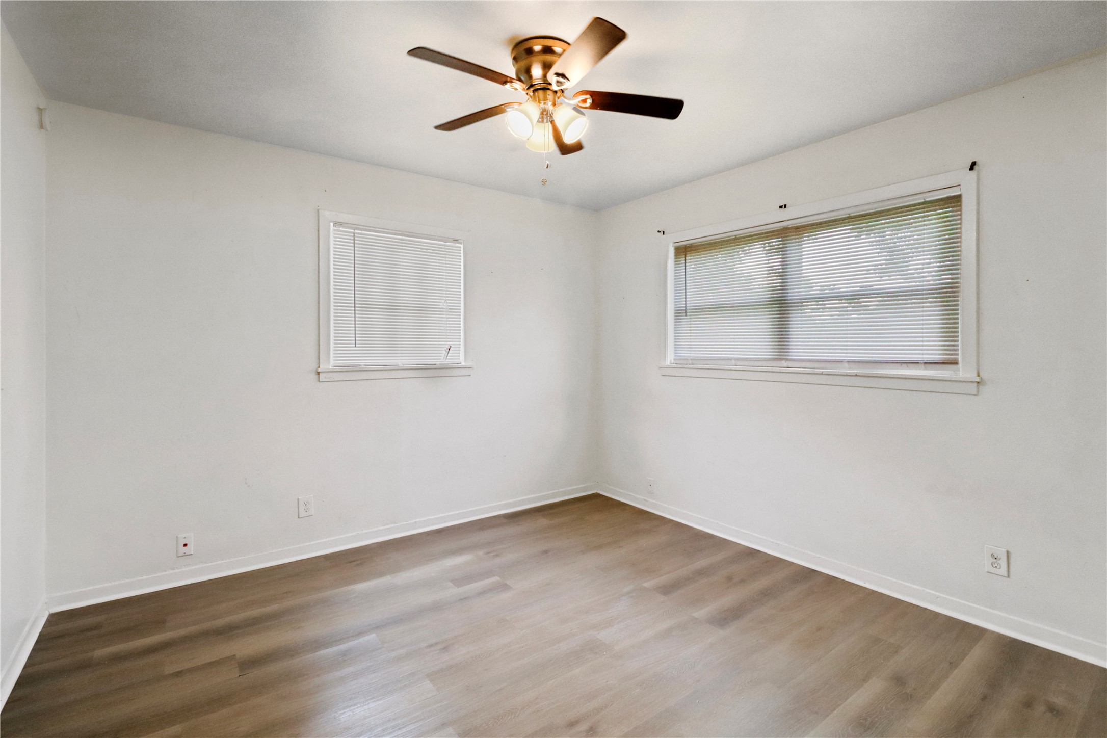 604 West Peach Street Angleton, TX 77515 - Photo 15 of 15 wooden floor in an empty room with a window