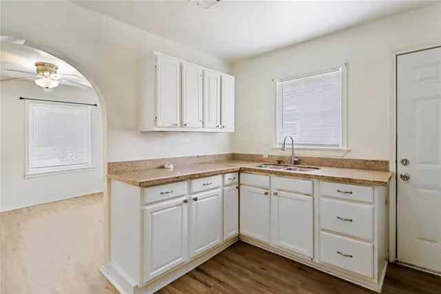 a kitchen with sink cabinets and wooden floor