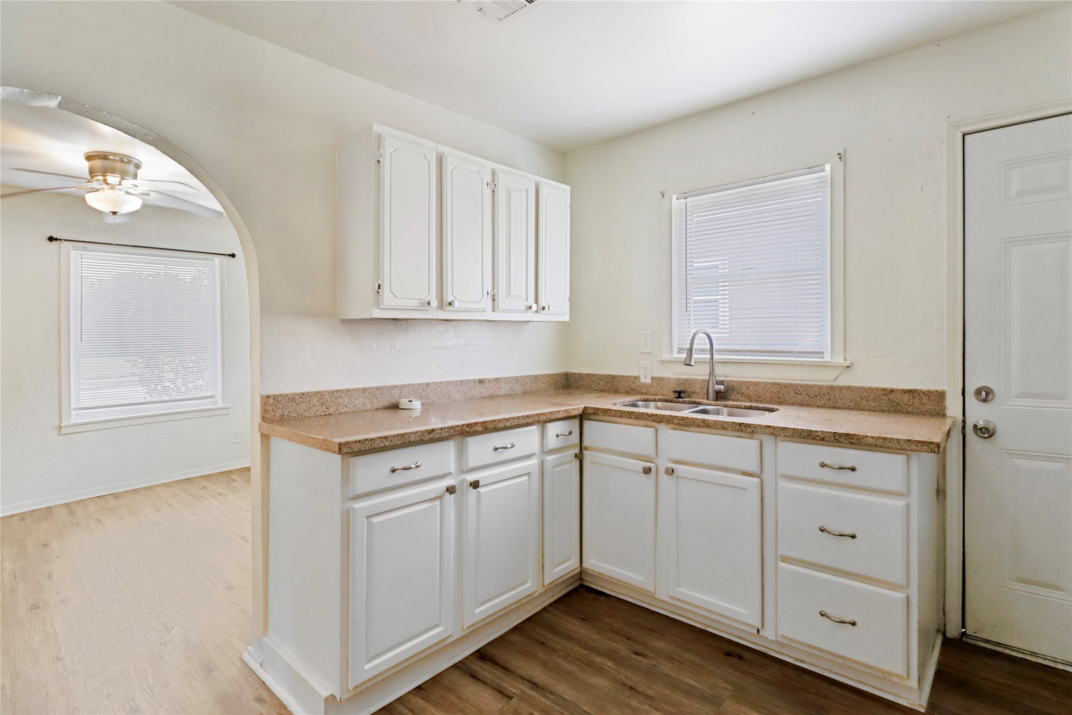 604 West Peach Street Angleton, TX 77515 - Photo 10 of 15 a kitchen with sink cabinets and wooden floor