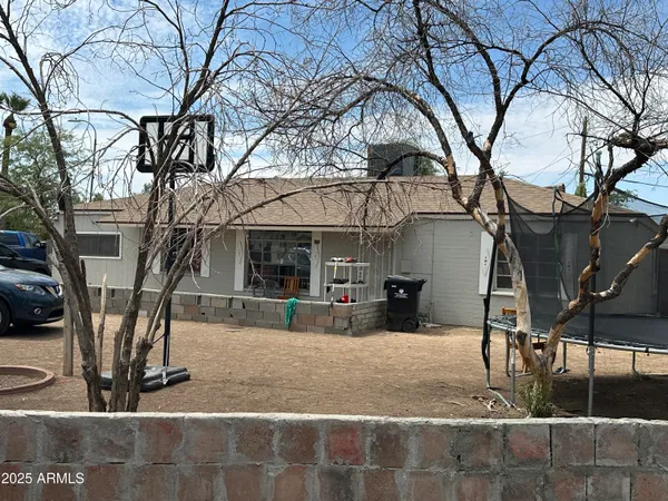 a view of a house with backyard and sitting area