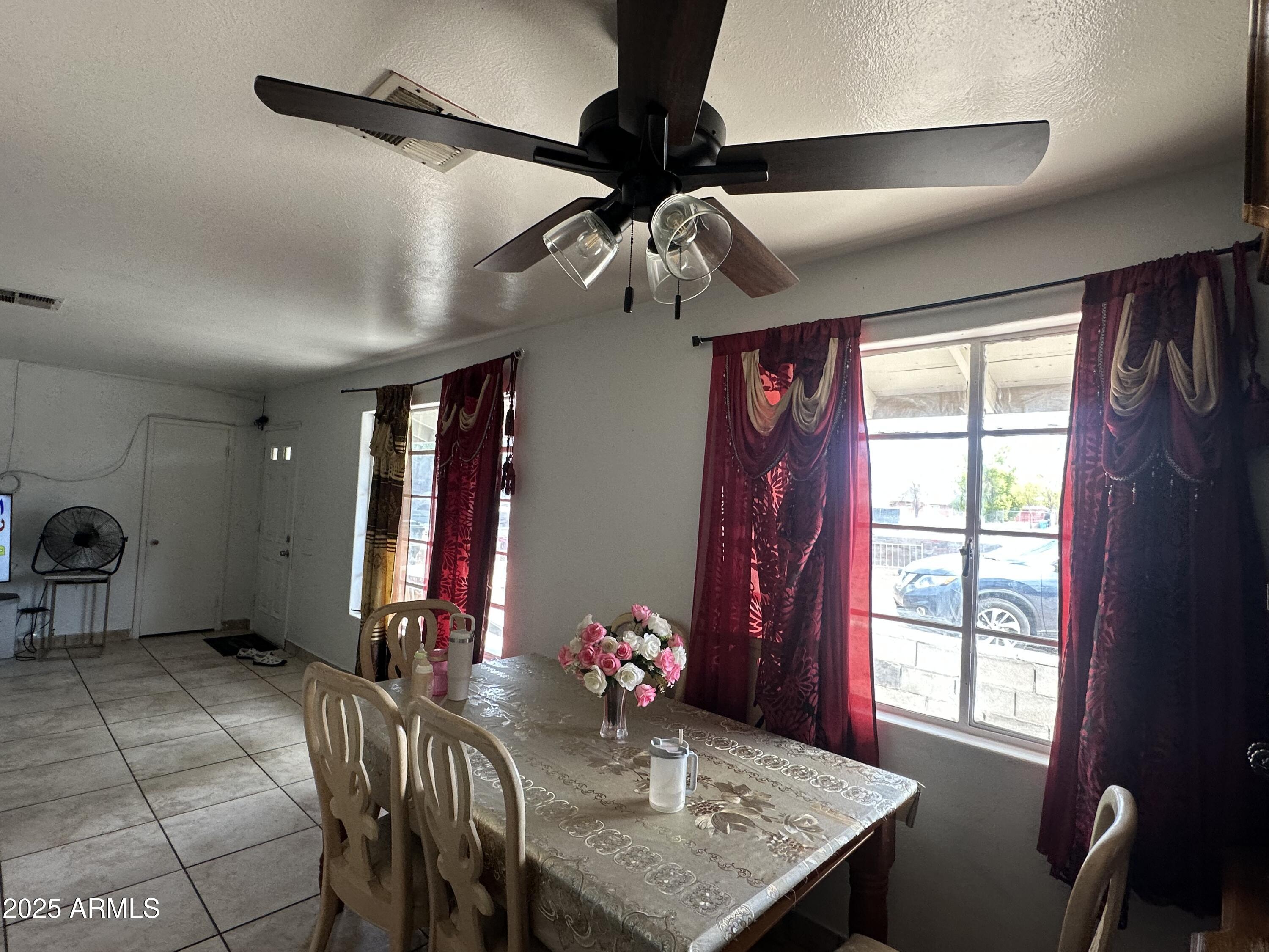 3117 West Roma Avenue Phoenix, AZ 85017 - Photo 11 of 30 a view of a dining room with furniture and chandelier