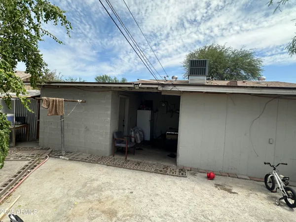 a backyard of a house with table and chairs