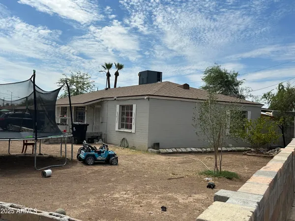 a view of a patio with table and chairs and potted plants