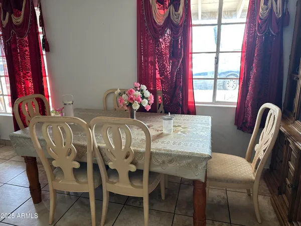 a view of a dining room with furniture and window