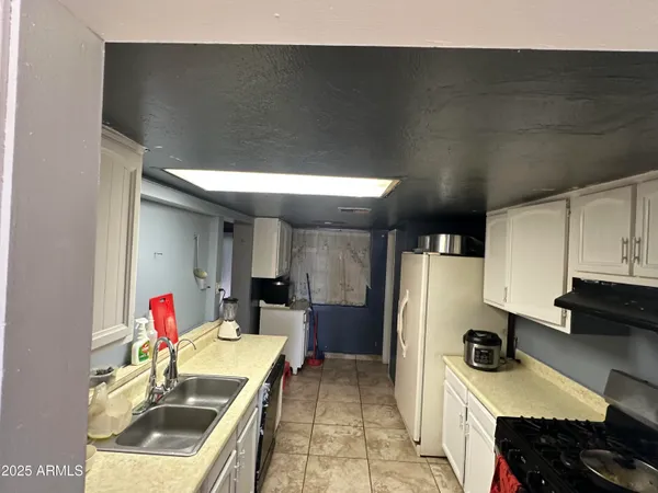a kitchen with stainless steel appliances a sink dishwasher and a refrigerator