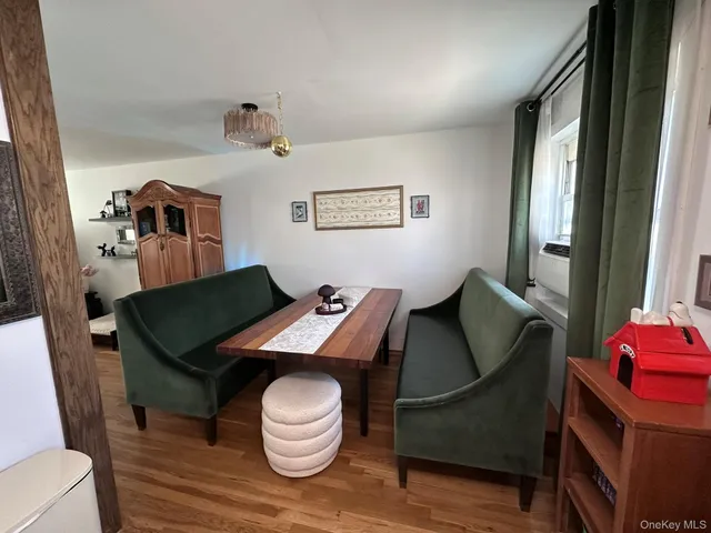 a view of a workspace with furniture and wooden floor