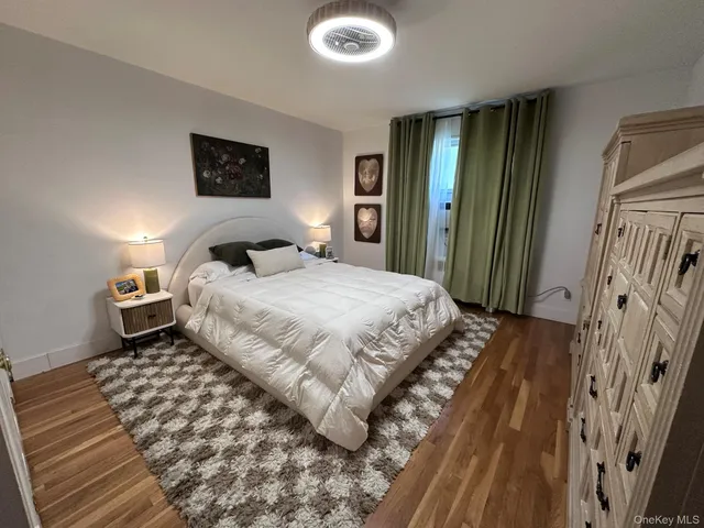 a bedroom with a bed and a mirror