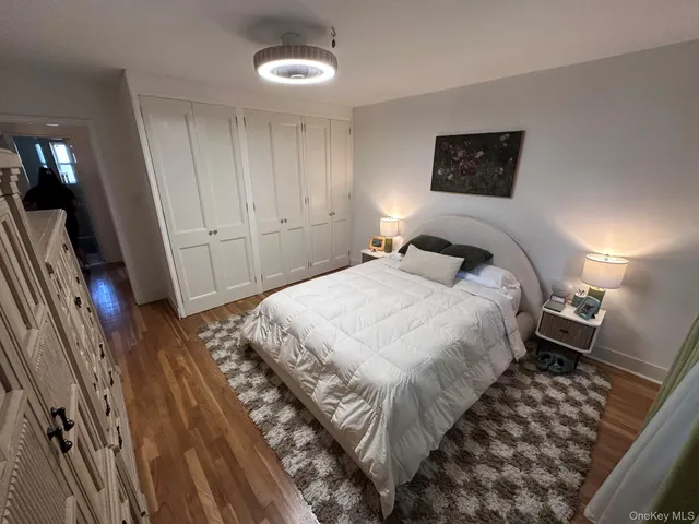 a bedroom with a bed and a mirror