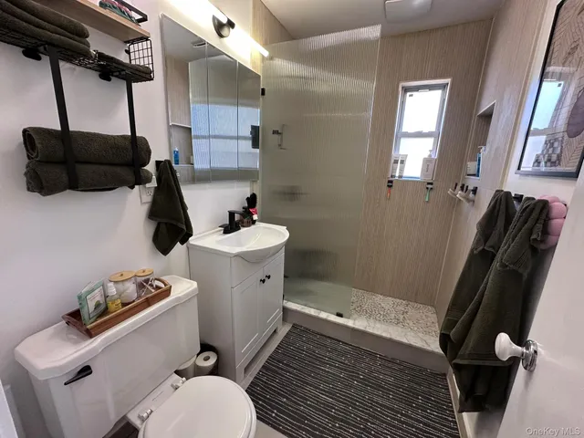 a bathroom with a sink toilet and shower