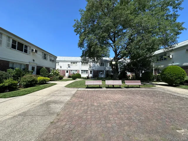 a view of a house with a yard and sitting area