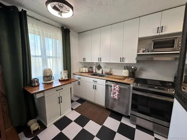 a kitchen with a stove a sink and a microwave