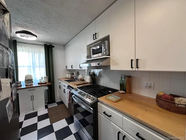 a kitchen with stainless steel appliances a stove a sink and a refrigerator