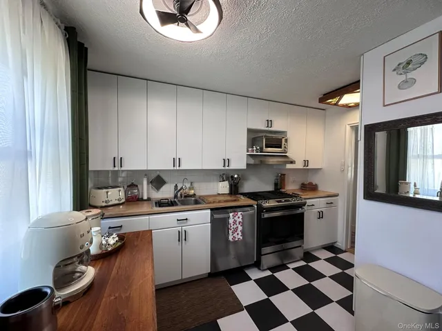 a kitchen with stainless steel appliances granite countertop a sink and cabinets