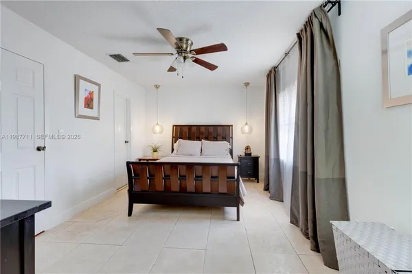 a bed room with a bed and a chandelier
