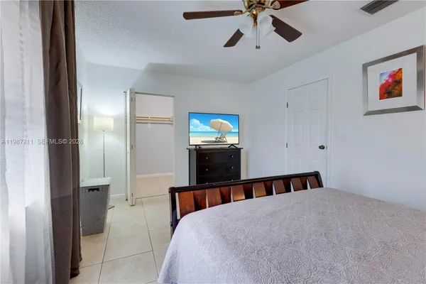 a bed room with a bed and a chandelier