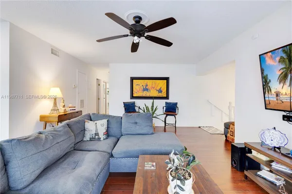 a living room with furniture and a flat screen tv