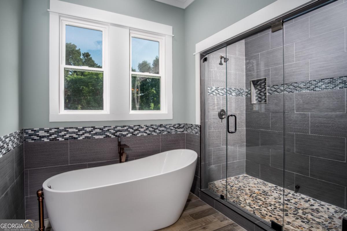 3 Cox Road Roswell, GA 30188 - Photo 21 of 37 a bathroom with a bathtub and shower