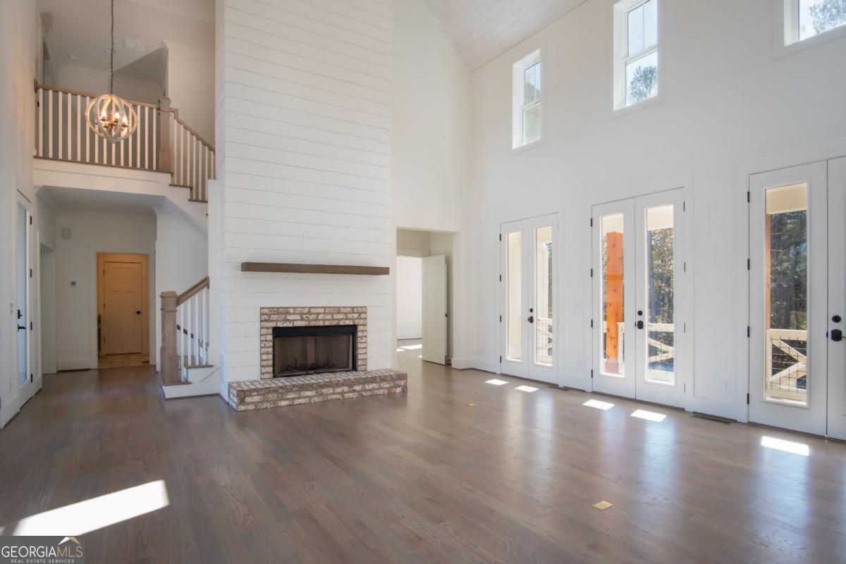 3 Cox Road Roswell, GA 30188 - Photo 27 of 38 a view of a big room with wooden floor fire place and windows