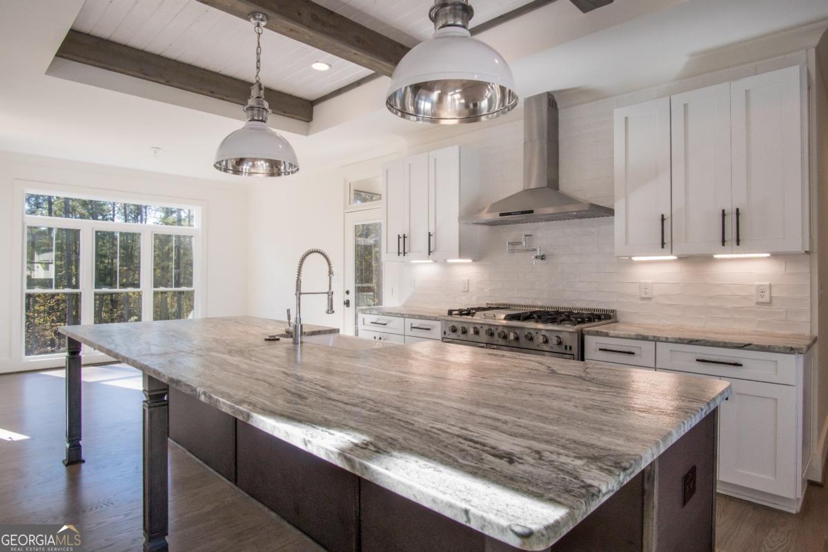 3 Cox Road Roswell, GA 30188 - Photo 28 of 38 a kitchen with stainless steel appliances granite countertop a sink a stove and a refrigerator