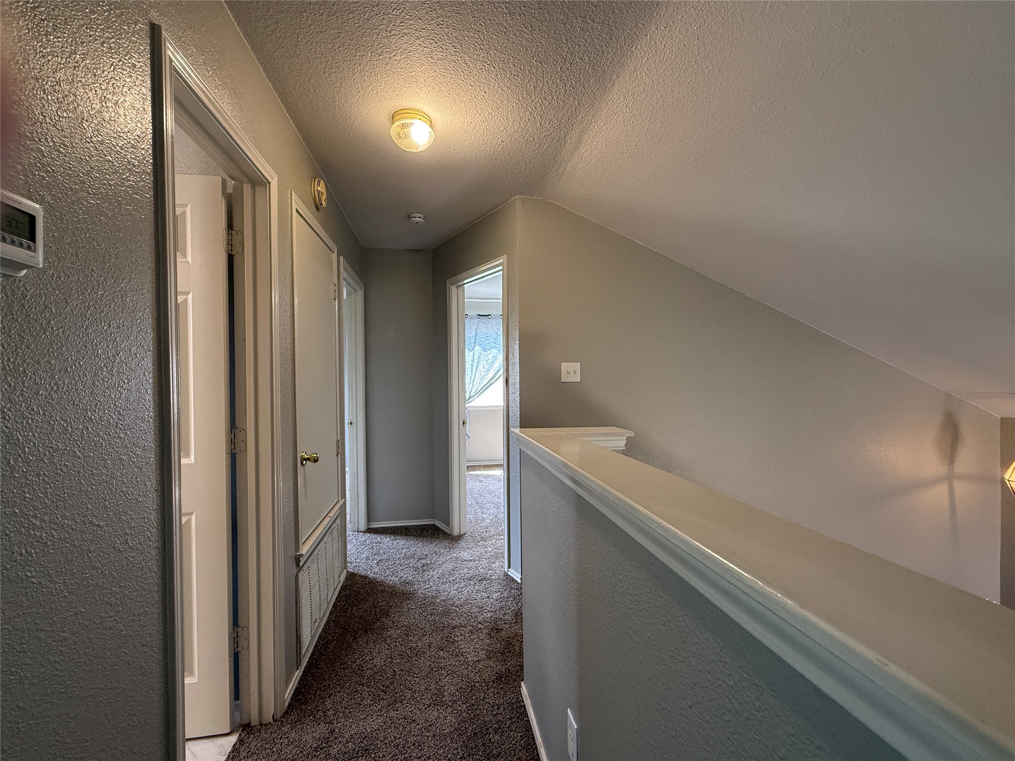 2120 Jester Farms Road Round Rock, TX 78664 - Photo 20 of 28 A well-lit second-story hallway with multiple access points to adjoining rooms.