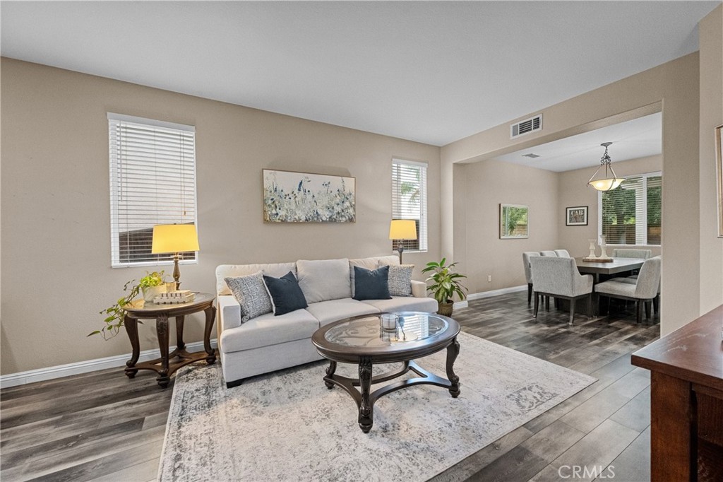 7220 Cumberland Place Rancho Cucamonga, CA 91739 - Photo 6 of 41 Bright, welcoming living room with a seamless view into the dining area.
