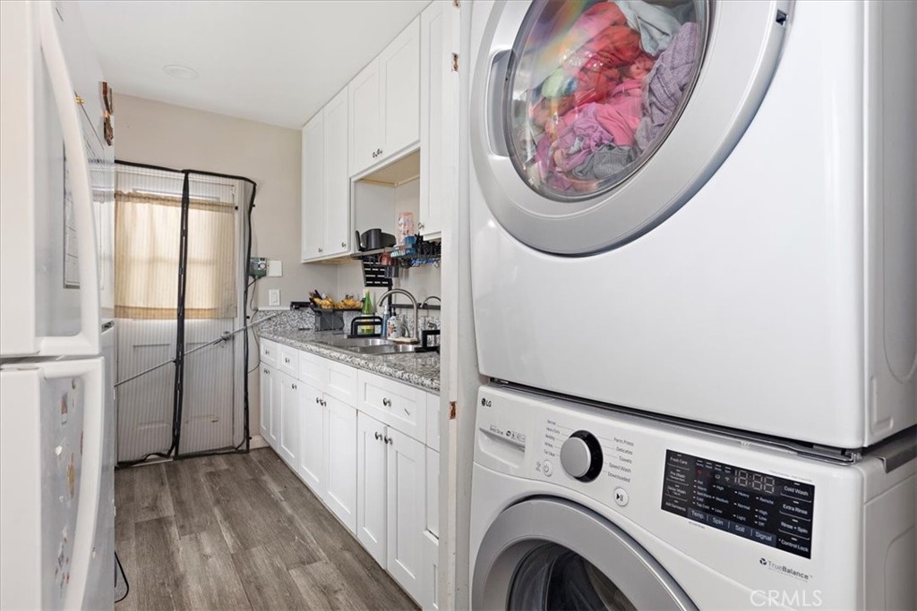 583 West Gray Street Colton, CA 92324 - Photo 11 of 22 a view of washer and dryer with kitchen in the background