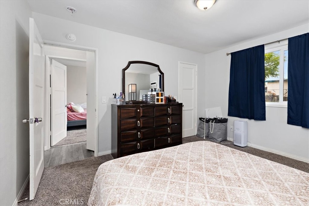 583 West Gray Street Colton, CA 92324 - Photo 12 of 22 a bedroom with a bed and a dresser