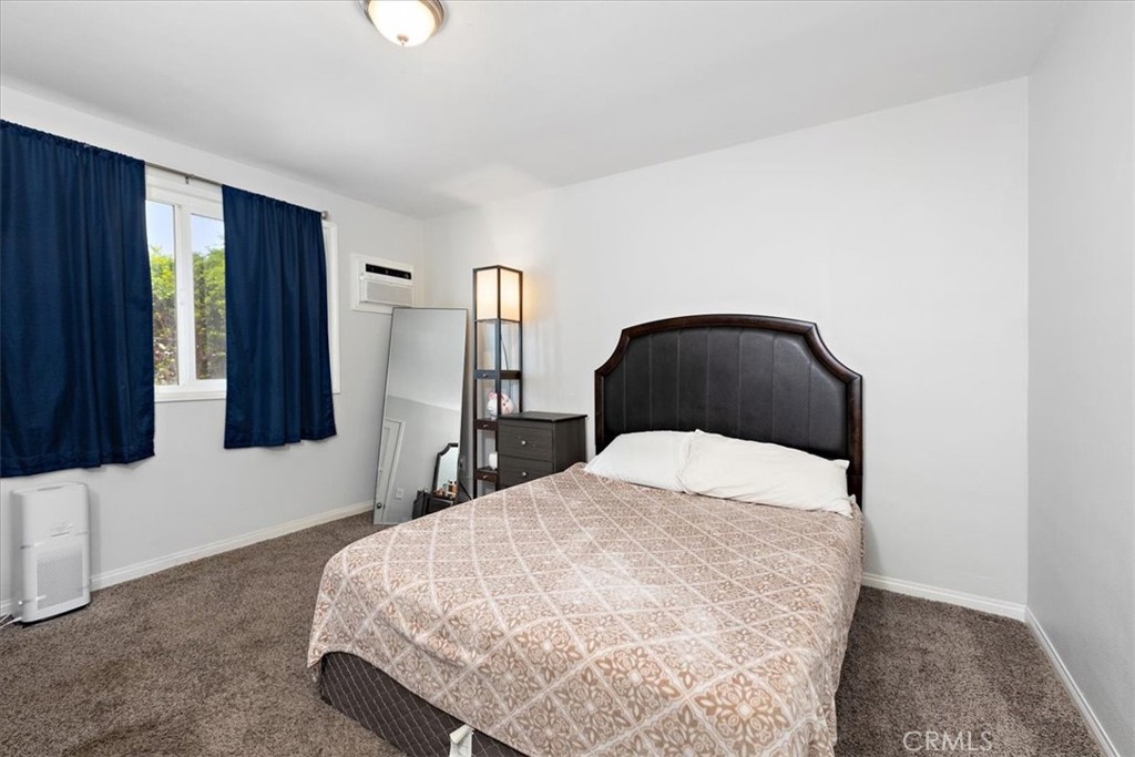 583 West Gray Street Colton, CA 92324 - Photo 13 of 22 a bedroom with a bed and a lamp