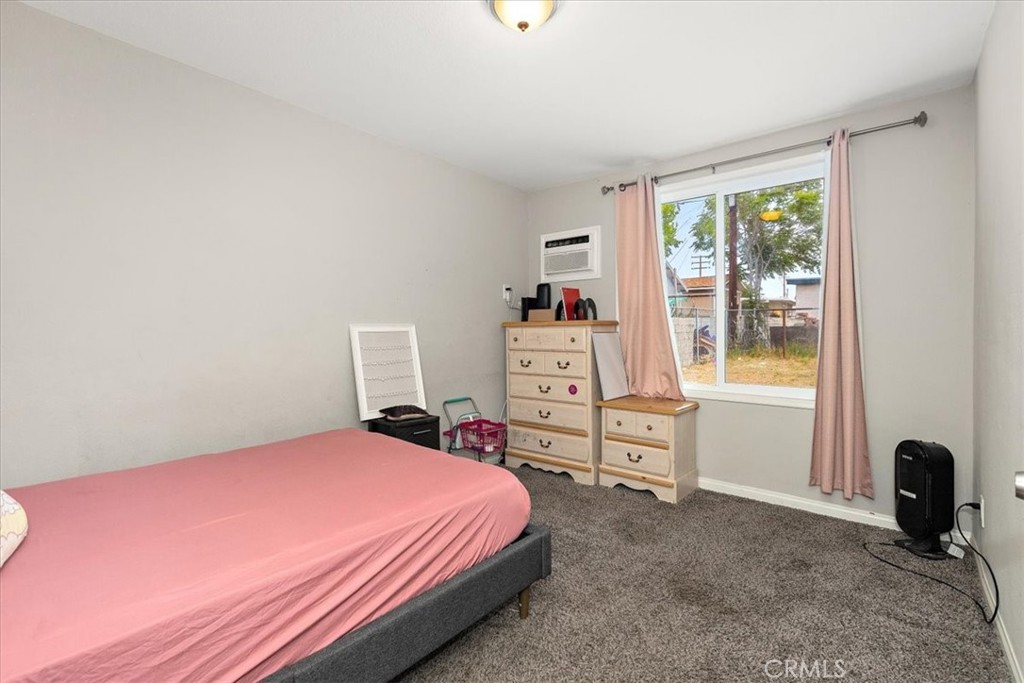 583 West Gray Street Colton, CA 92324 - Photo 15 of 22 a bedroom with a bed and a desk with chair