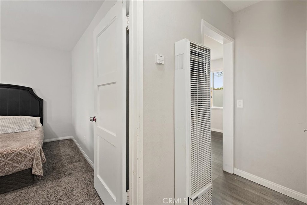 583 West Gray Street Colton, CA 92324 - Photo 16 of 22 a bedroom with a bed and wooden floor