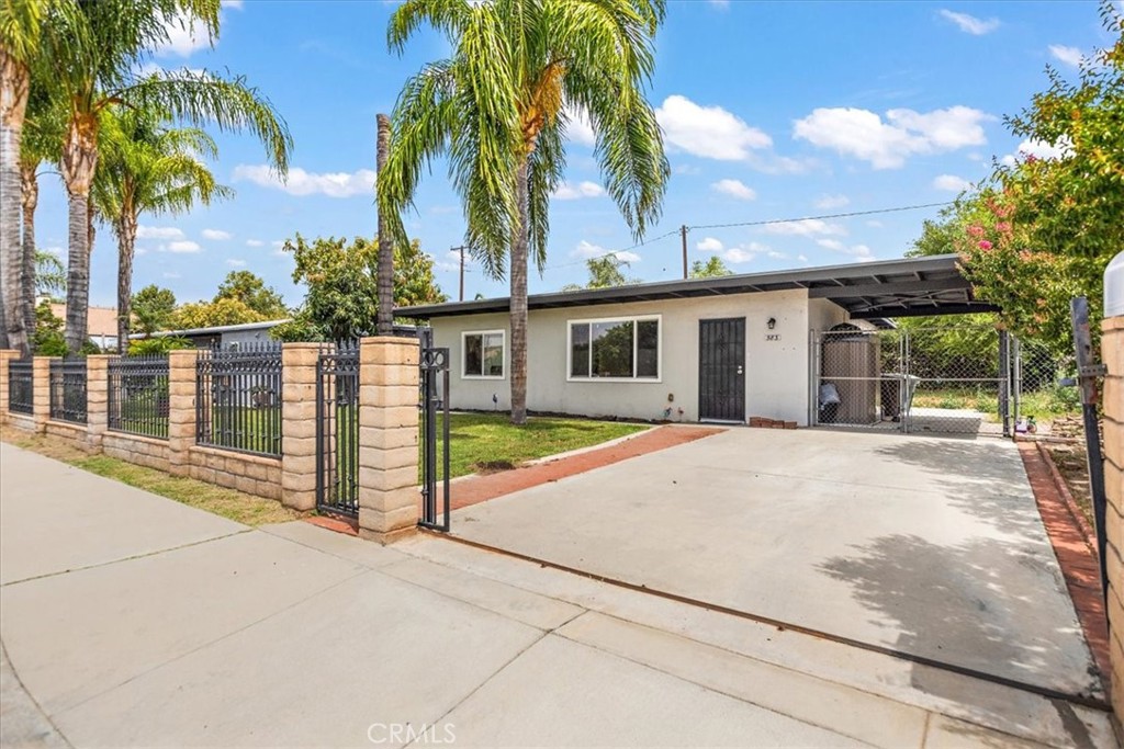 583 West Gray Street Colton, CA 92324 - Photo 2 of 22 a house with palm tree in front of it