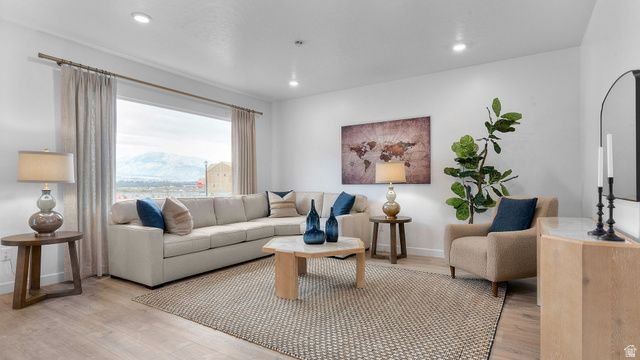 2032 East Dorset Way, Unit 286 Salem, UT 84653 - Photo 5 of 23 Expansive living area featuring light wood-finish flooring, recessed lighting, and a large picture window with mountain scenery