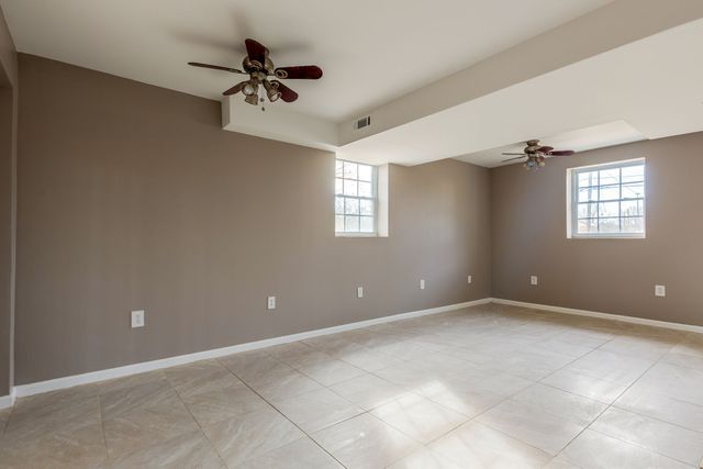 a view of a house with backyard and a tree