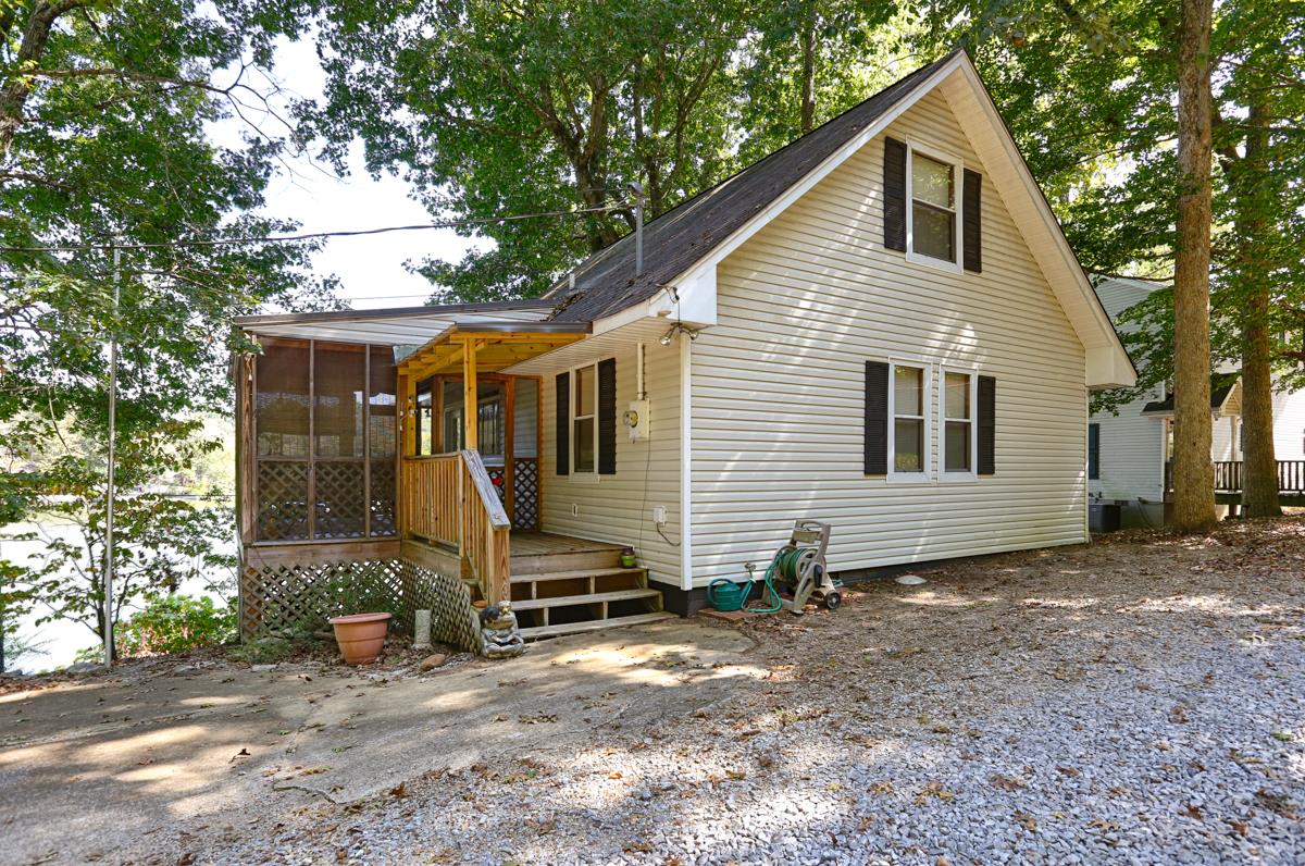 741 Lake Logan Road Ardmore, TN 38449 - Photo 3 of 13 a view of a small house and a yard