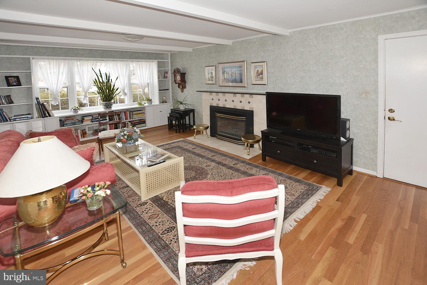 6906 Spur Road Springfield, VA 22153 - Photo 12 of 28 a living room with furniture a flat screen tv and a fireplace