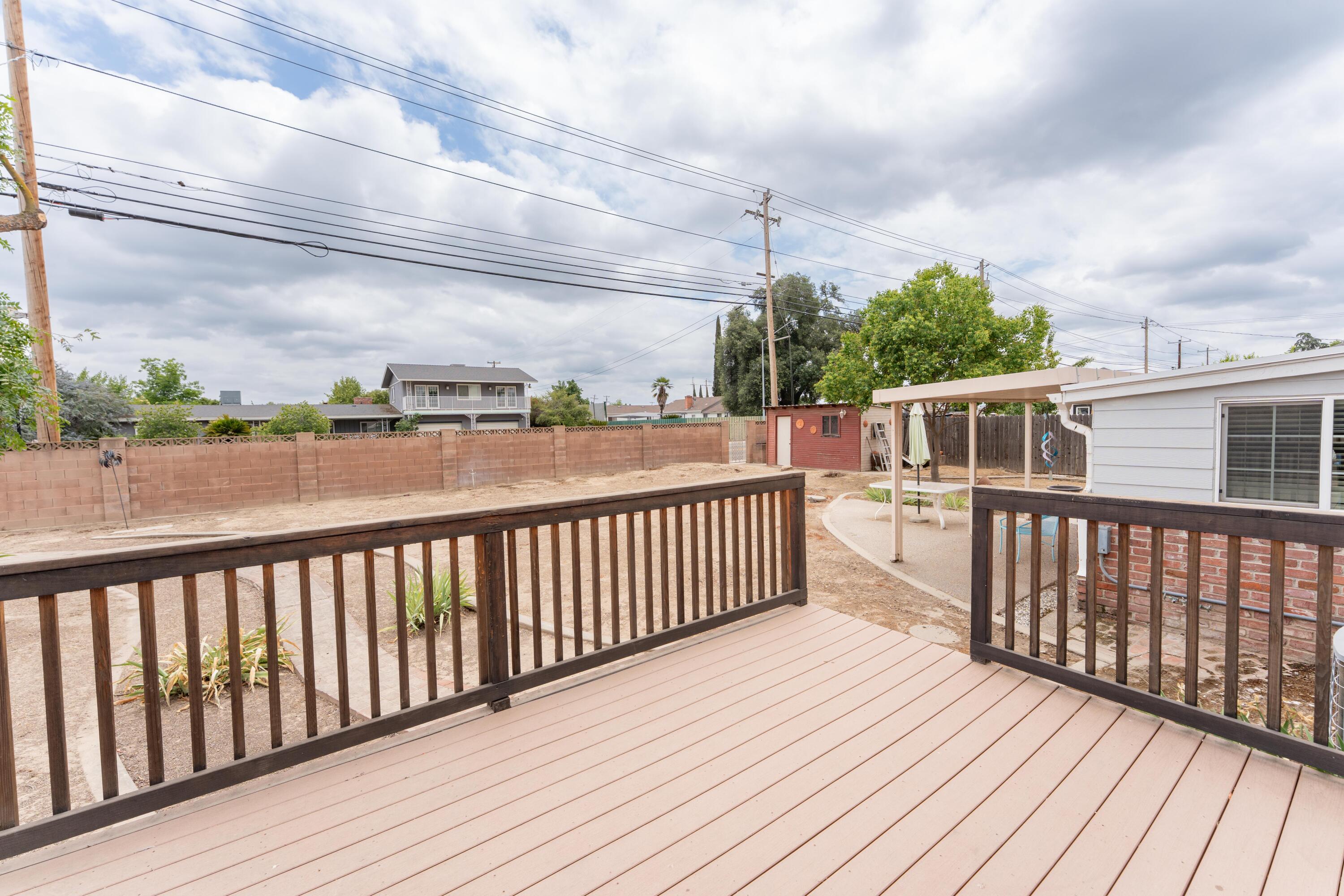 570 North Birch Avenue Reedley, CA 93654 - Photo 40 of 52 a balcony with wooden floor and fence