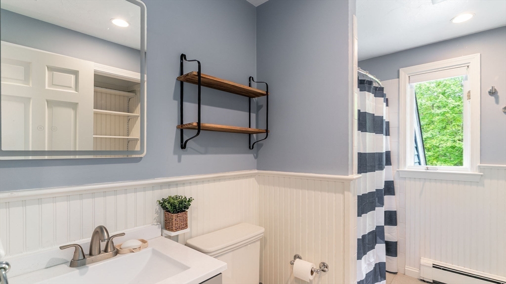 142 Baker Street Walpole, MA 02081 - Photo 36 of 42 a bathroom with a sink and a mirror