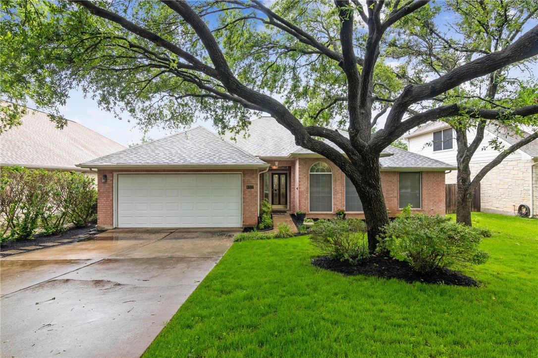6312 Taylorcrest Drive Austin, TX 78749 - Photo 1 of 1 a front view of a house with a garden and tree
