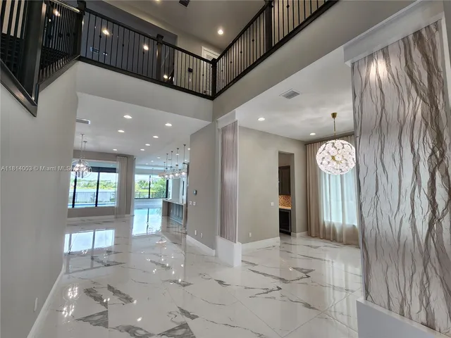 a view of a glass door with a tv from a window