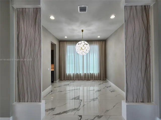 a view of a porch with chairs and backyard