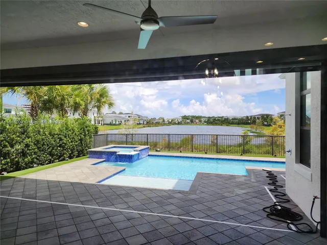 a large kitchen with a sink a counter space and stainless steel appliances