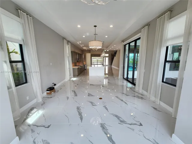 a view of room with wooden floor and floor to ceiling window