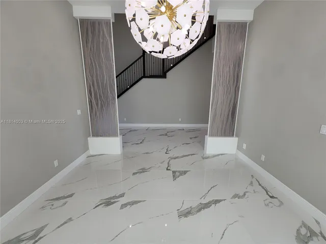 an empty room with windows and entrance