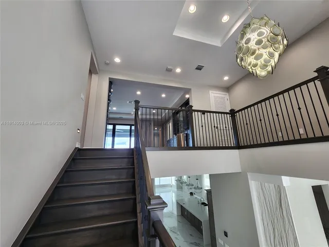 a view of a patio with table and chairs and potted plants