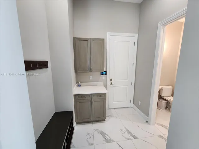 a large kitchen with a large counter top stainless steel appliances and cabinets