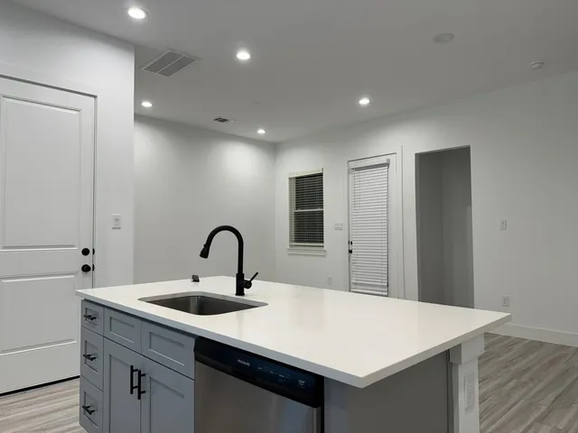 a kitchen with a sink and a refrigerator