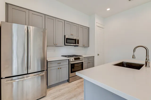 a kitchen with a refrigerator sink and stove
