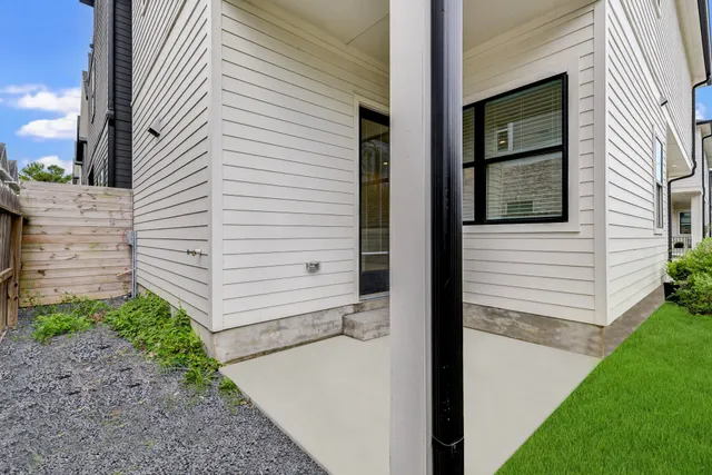 a view of a door of a house with a backyard
