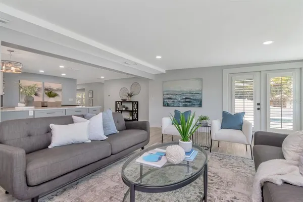 a front view of a house with a yard and potted plants